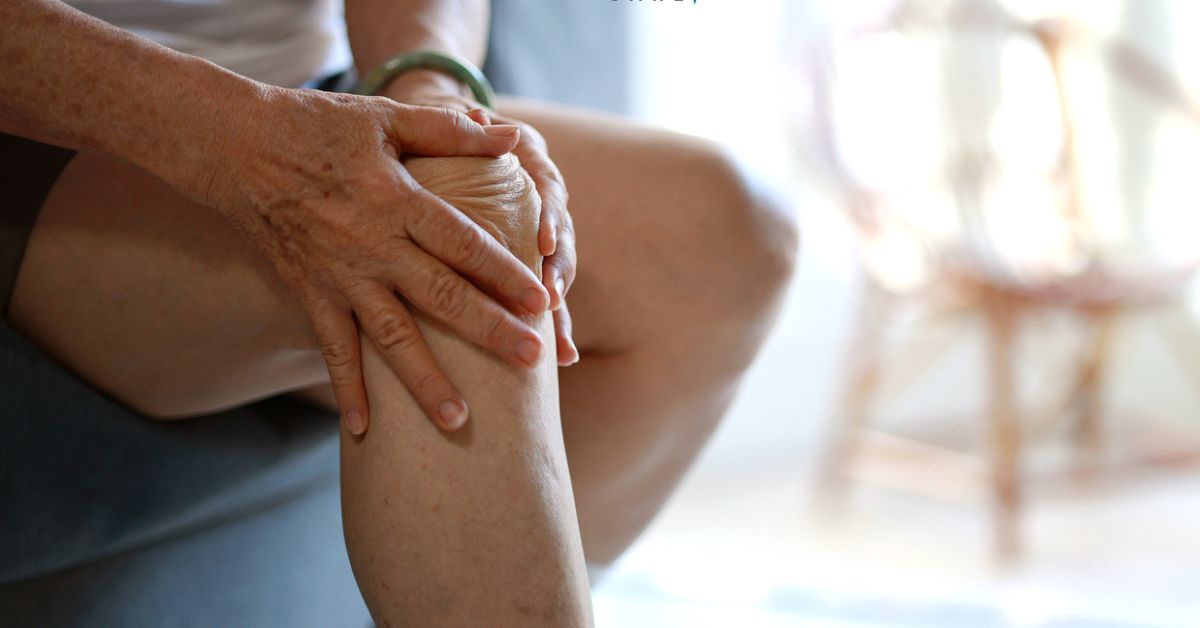 Older person holding knee due to pain