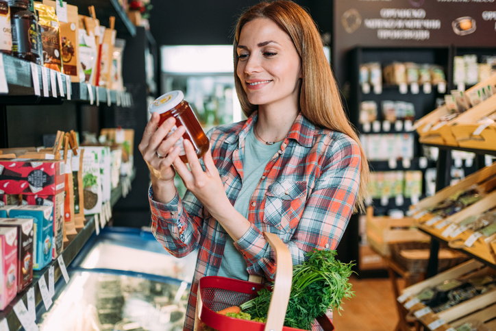 Woman looking at honey on the shelf